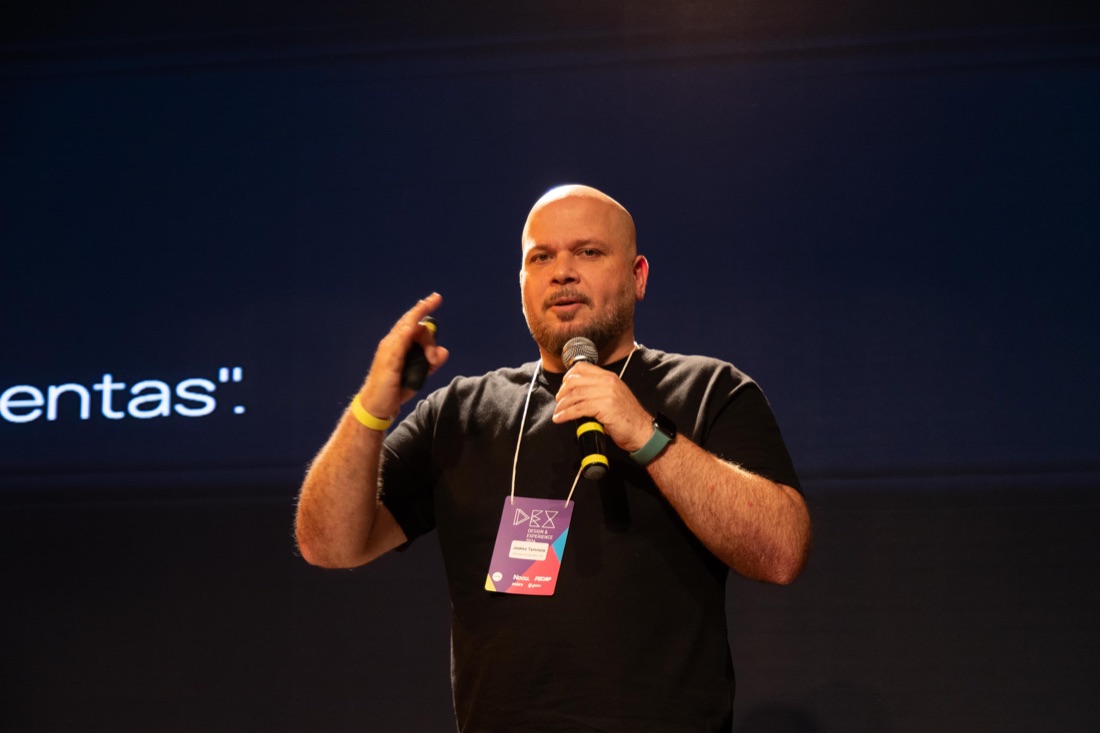 Jaakko Tammela speaking on stage at DEX